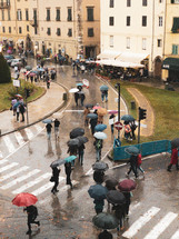 crowds of people walking in the street with umbrellas in the rain 