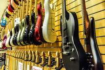 guitars hanging in a music store 