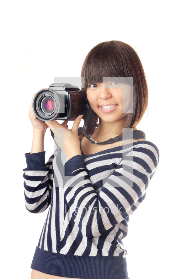 a girl holding a large camera 