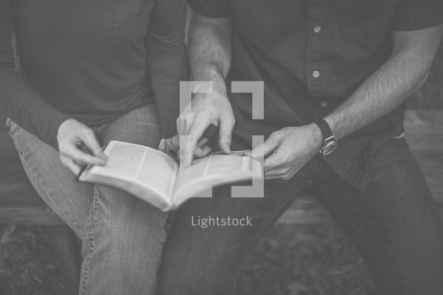 A man and woman reading the Bible together