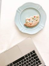 cookie on a plate and laptop computer 