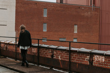 a woman walking on a rooftop 