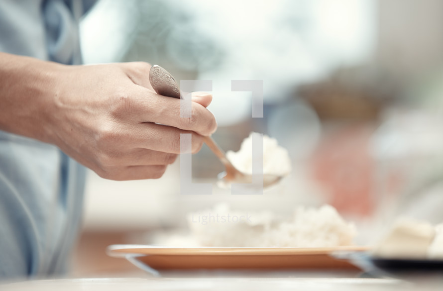 a person eating rice 