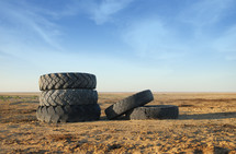 five tires in dirt 