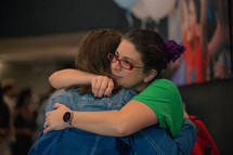 two women hugging 