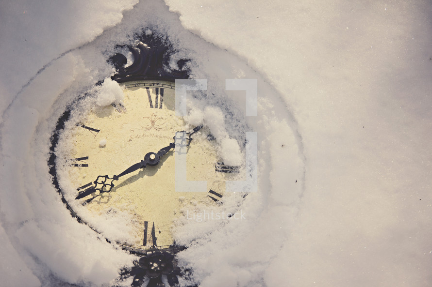 A clock covered in snow.