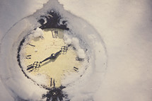 A clock covered in snow.
