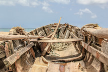 paddles in a rugged and weathered old wooden boat 