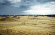 rural road through rolling hills of a prairie 