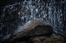water falling on a rock 