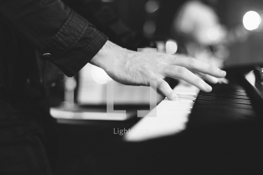 Hands on a piano.