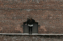a female balancing on a ledge 