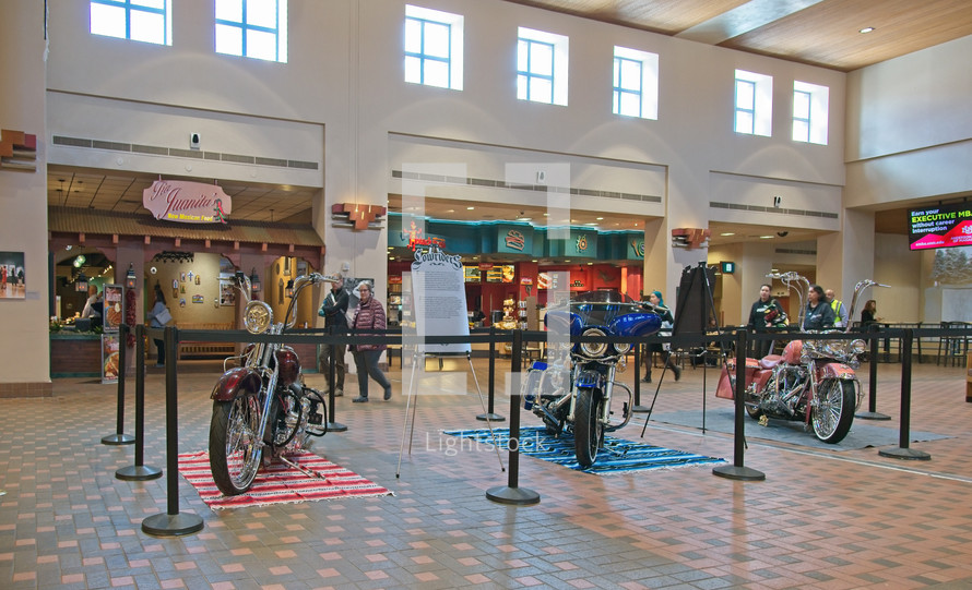 motorcycles on display in a food court 