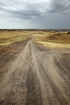 dirt road over rolling hills 