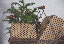 small pine tree and presents in a basket 
