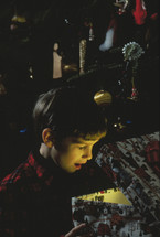 child opening a Christmas gift 