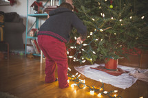 a boy decorating a Christmas tree