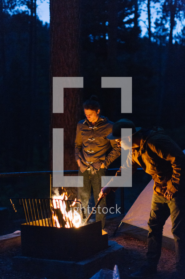 men standing near a campfire at night 