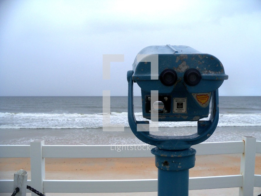 A viewfinder scope looking out at the sea from a high bluff at a local beach side resort over looking the ocean. 