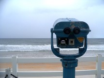 A viewfinder scope looking out at the sea from a high bluff at a local beach side resort over looking the ocean. 