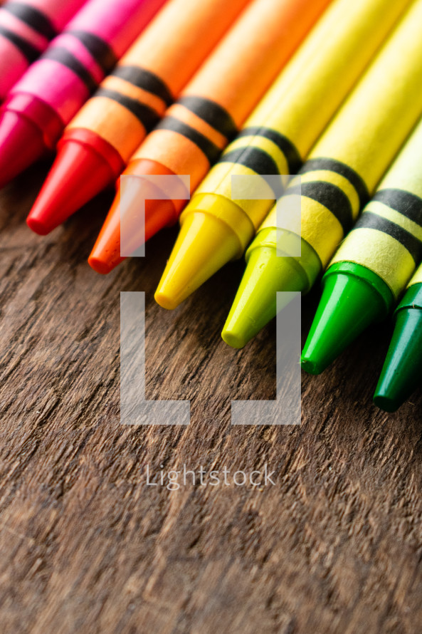 crayons on a wood background 