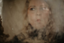 portrait of a woman through frosted glass