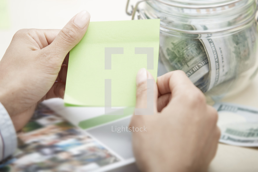 a person holding a blank sticky notes 