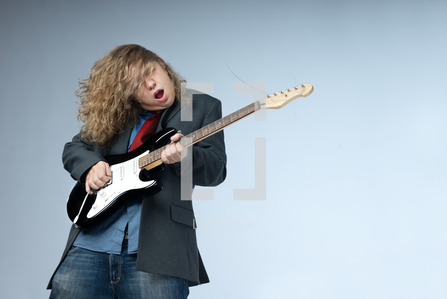 man jamming on a guitar 