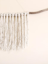 yarn tassels on a branch 