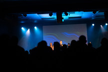 silhouettes of people at a worship service 