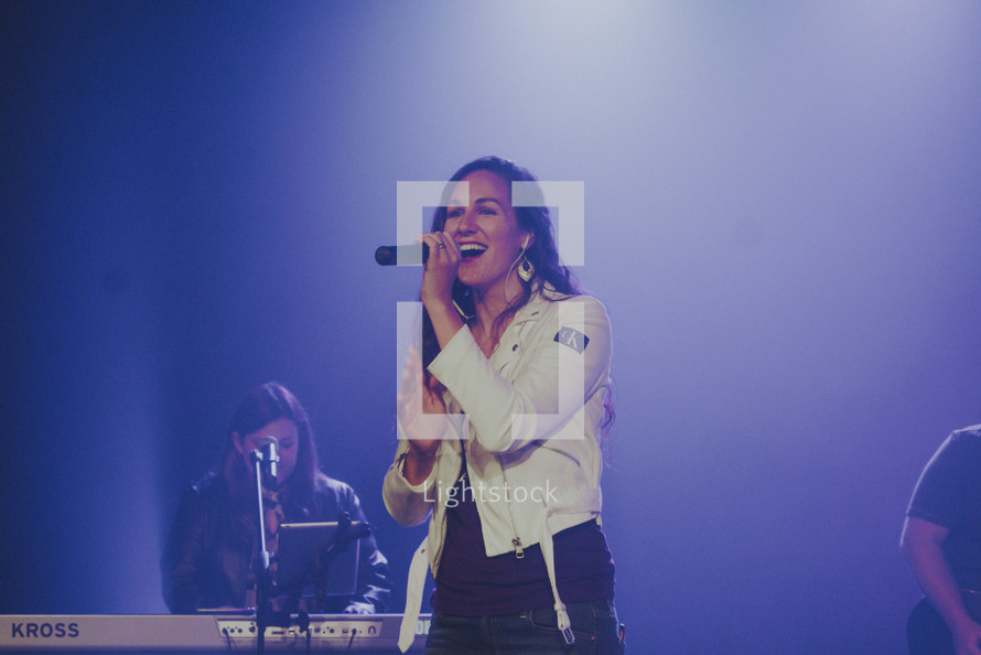 a worship leader singing on stage 