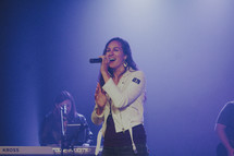 a worship leader singing on stage 