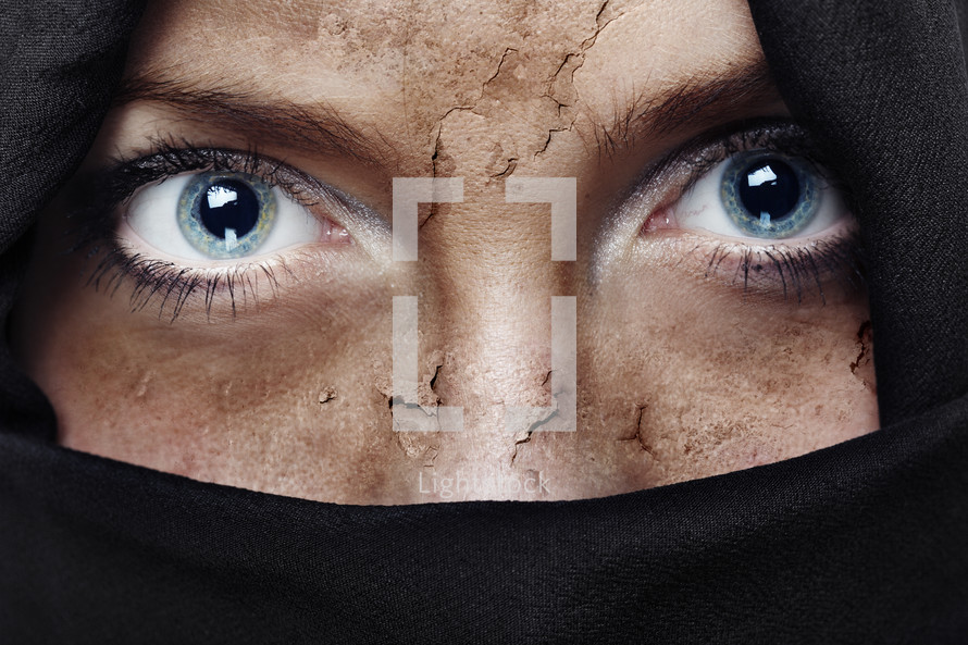 peeling face of a veiled woman