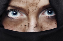 peeling face of a veiled woman