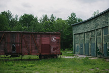 An old, abandoned train car and shed.
