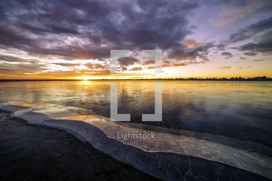 Lon Hagler Reservoir located in Loveland Colorado on a beautiful and colorful cloud filled sunrise
