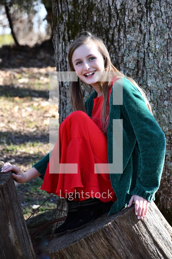 portrait of a smiling teen girl wearing red and green at Christmas 