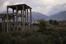 Rough looking buildings and ruins in Eastern Europe with mountains in background