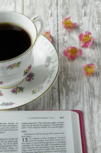 open Bible and floral print coffee cup 