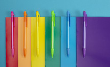 mechanical pencils and paper in rainbow colors 
