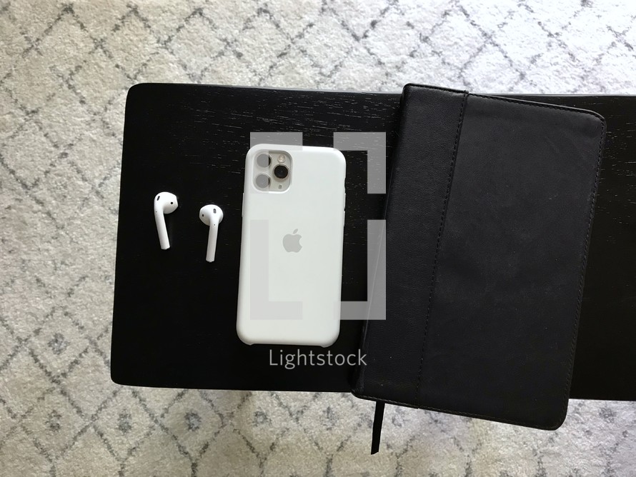 iPhone, AirPods, and journal 