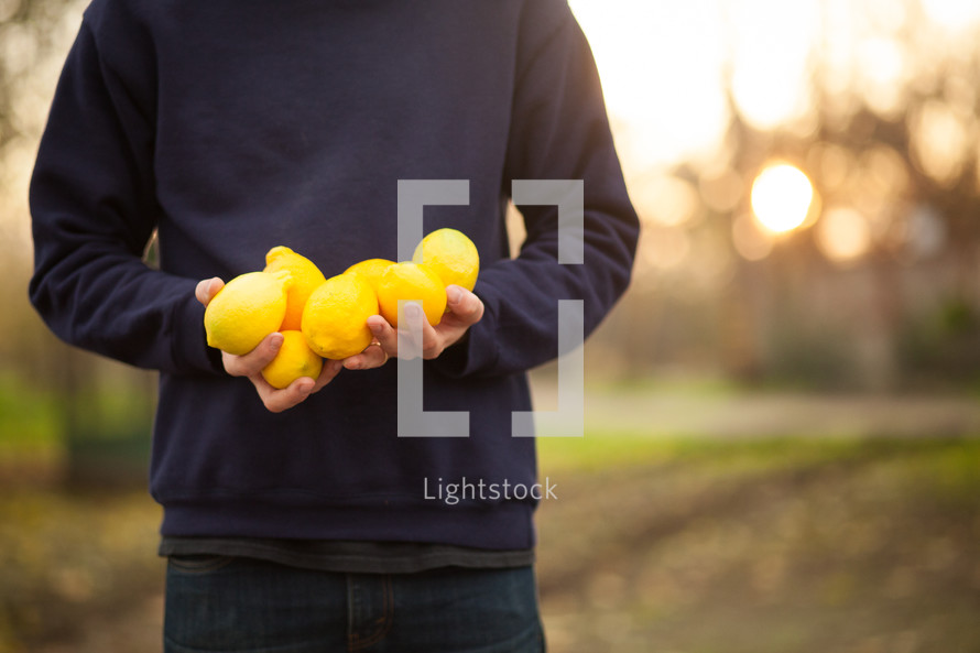 a man holding lemons