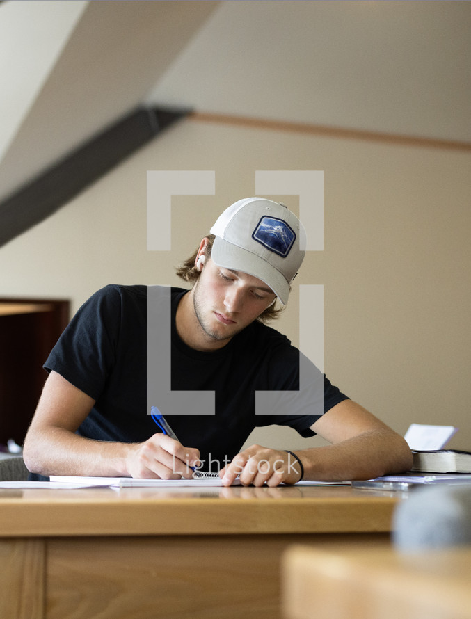 young man sitting at desk studying