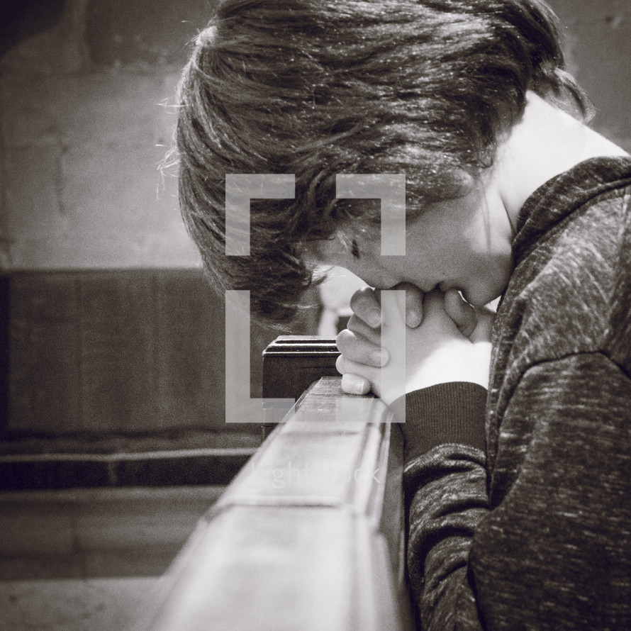boy praying in a church 