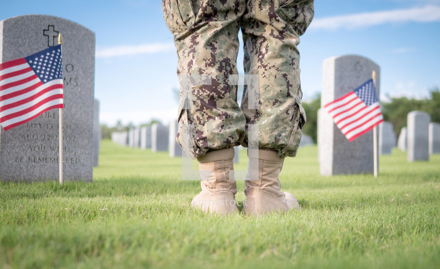 solider praying at Arlington National Cemetery 