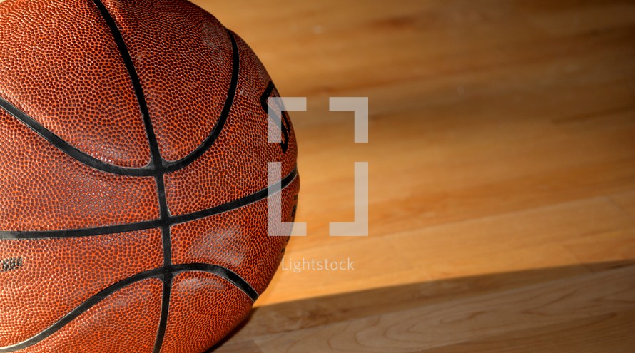 basketball on a wooden basketball court 