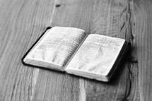 open Bible on wood table 