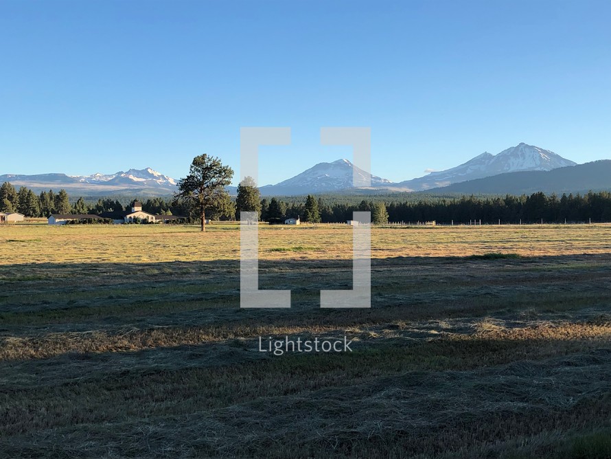 An empty field with mountains in the background