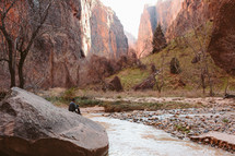 a man sitting in the bottom of a canyon 