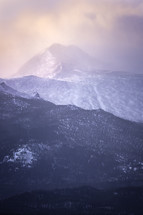 Colorful morning light hits the summit of Longs Peak on a snowy winter day